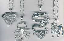 Superman, Scorpion, Dragon and bull dog charms on figaro chains
